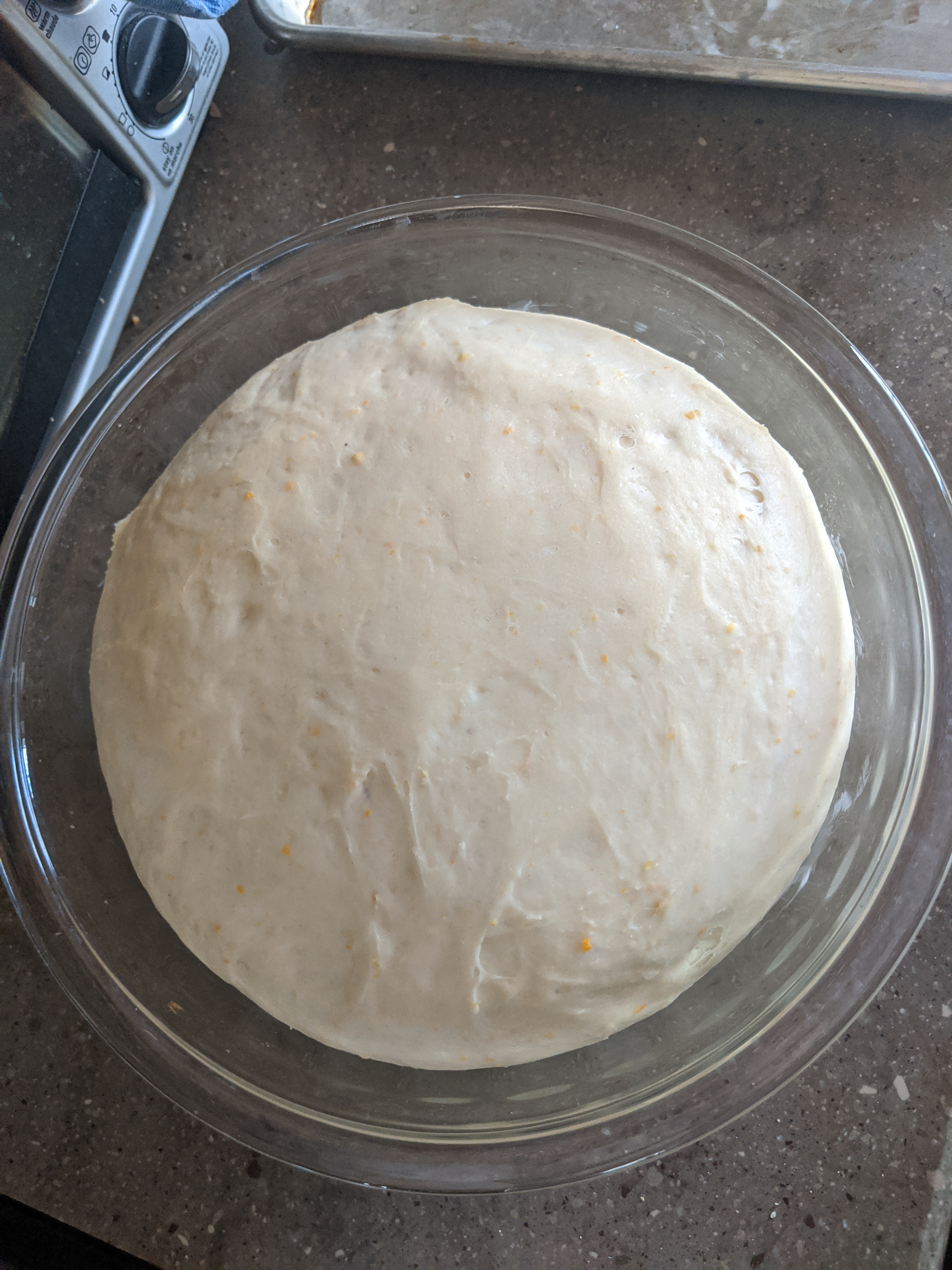 A large bowl of uncooked, risen dough